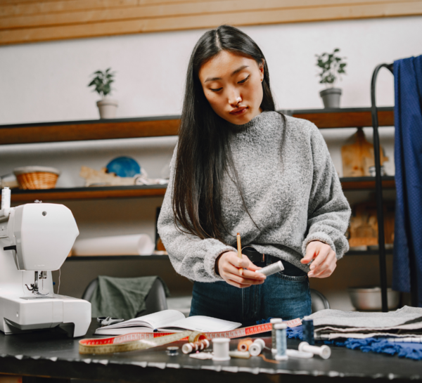 Image shows a person planning on a sewing project.