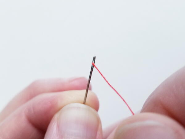 Threading a sewing needle