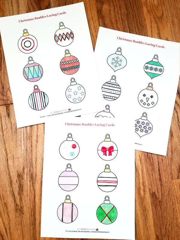 Image shows the colored in Christmas Baubles Printable Lacing Cards