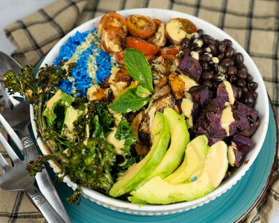 Tempeh Fajita Burrito Bowl With Blue Rice, Sautéed Purple Yams, And A Spicy Chipotle Dressing