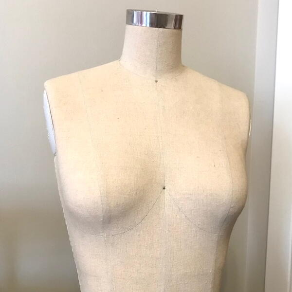 Image shows a mannequin used in draping and clothing design.