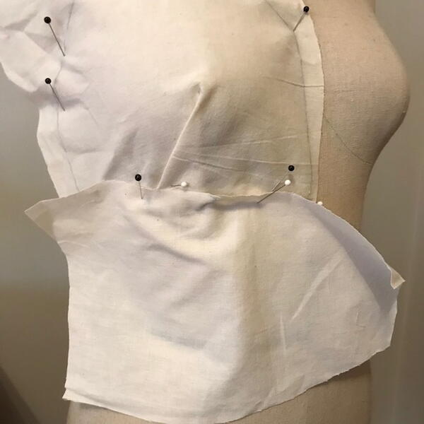 Image shows fabric pinned and marked for the draping process.