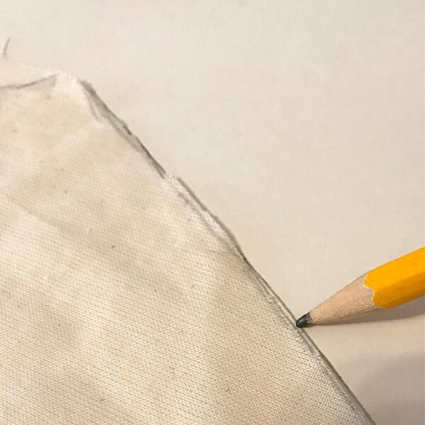 Image shows fabric pinned and marked to create reusable pattern.