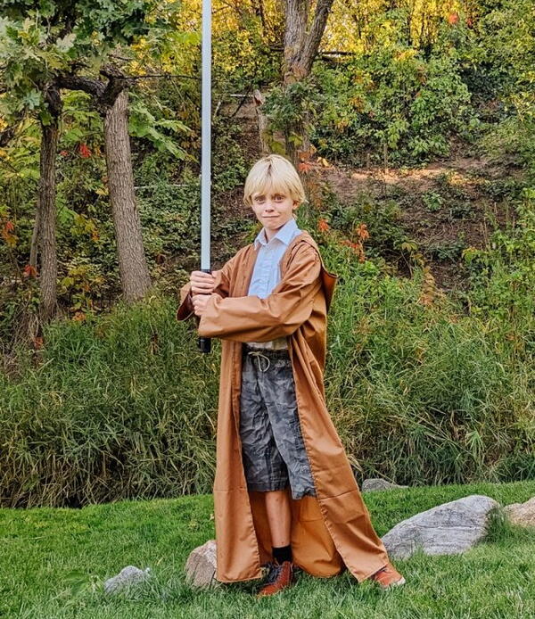 Image shows a child outside posing in the SW Costume Robe.